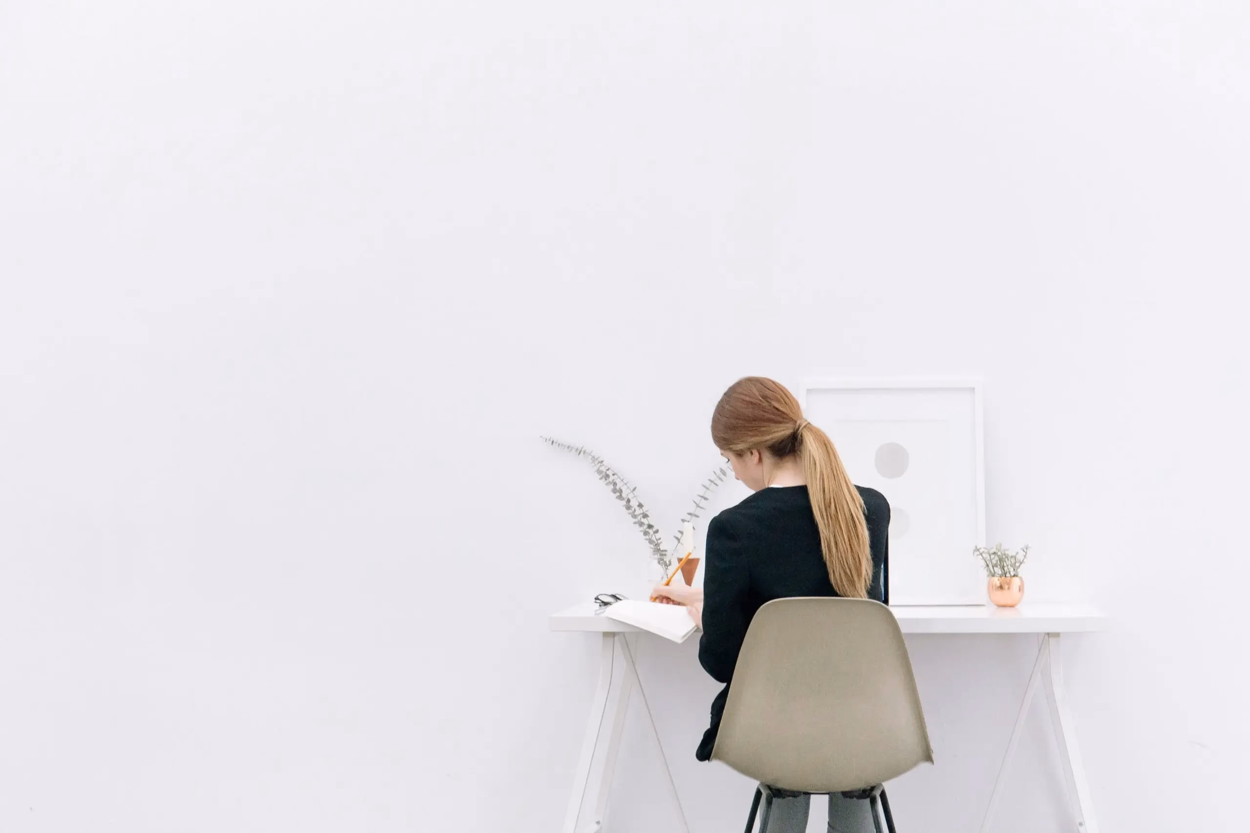 Woman working at a minimalist desk