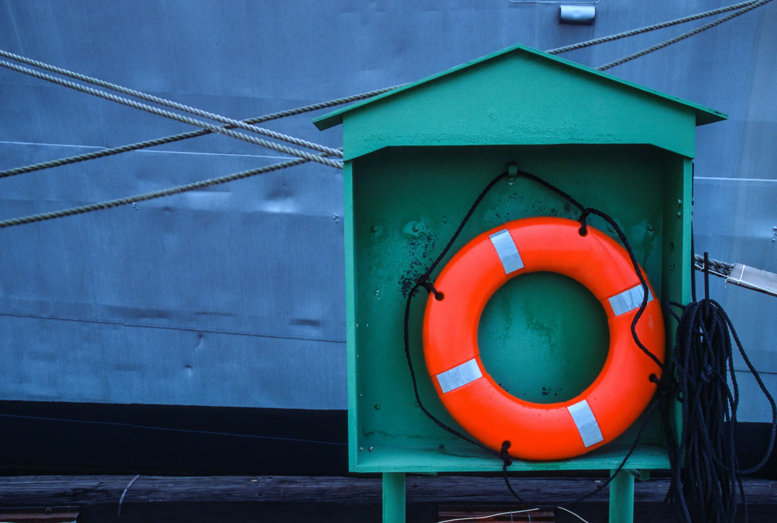 A life preserver in front of a large ship