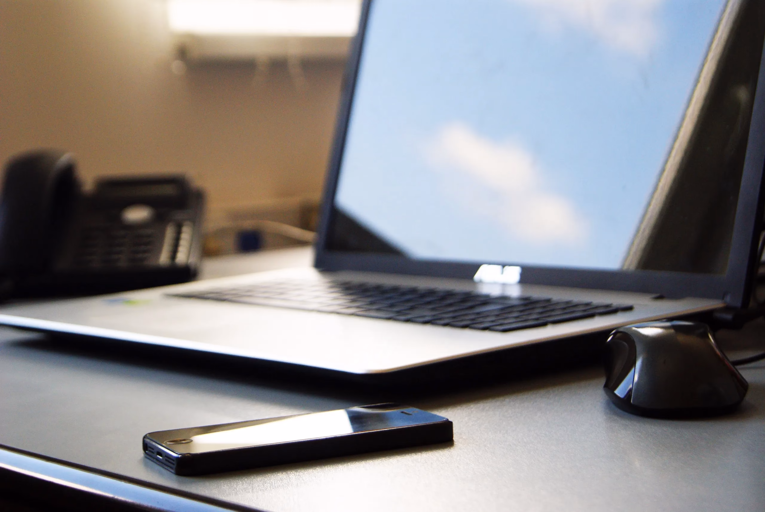 Laptop, smartphone and mouse on a desk