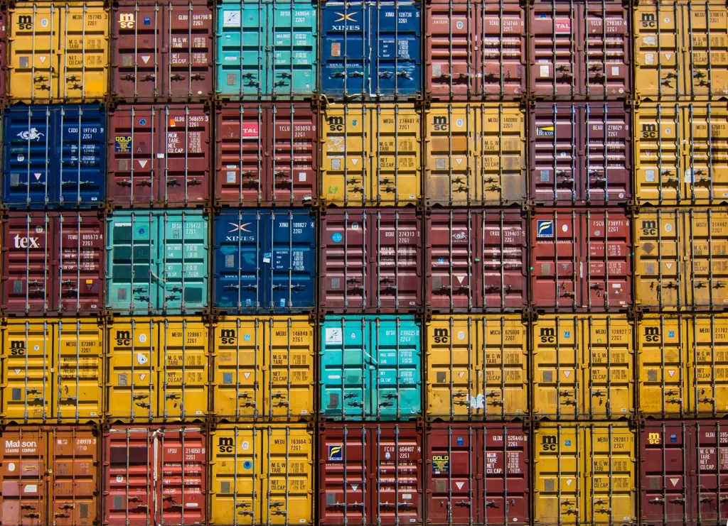 Stack of shipping containers of various colours
